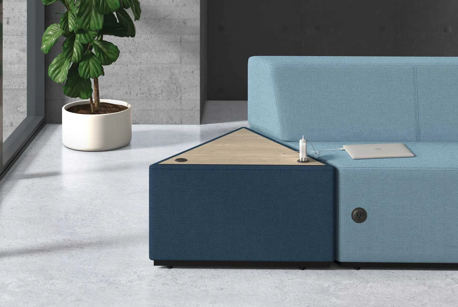 HON Tangram in-line table with power capabilities charging a laptop.