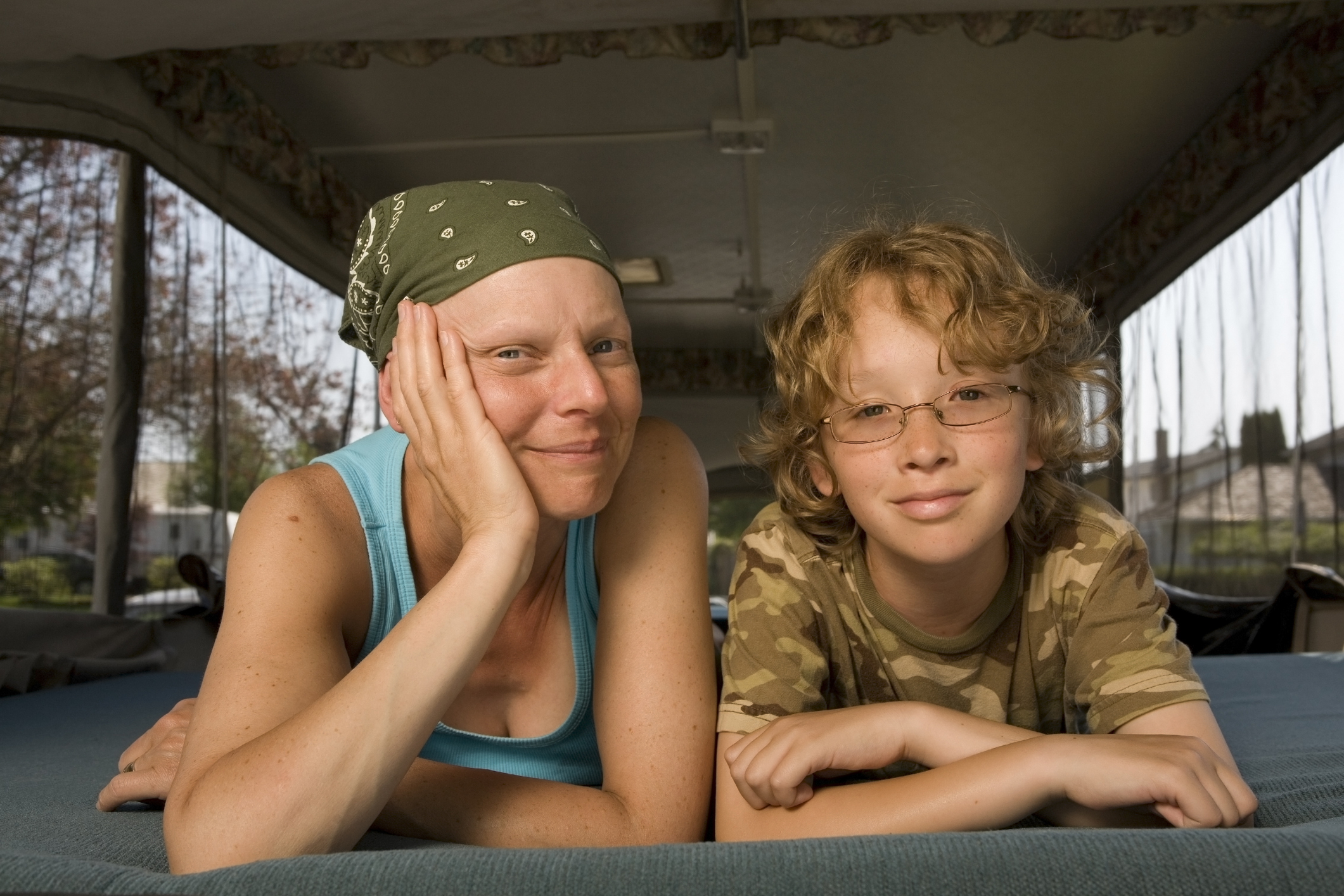 Mother fighting cancer with her son looking into camera,